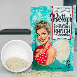 A bag of betty 's bombshell buttermilk ranch seasoning next to a bowl.