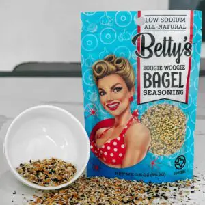 A bag of betty 's house-made bagel seasoning next to a bowl.