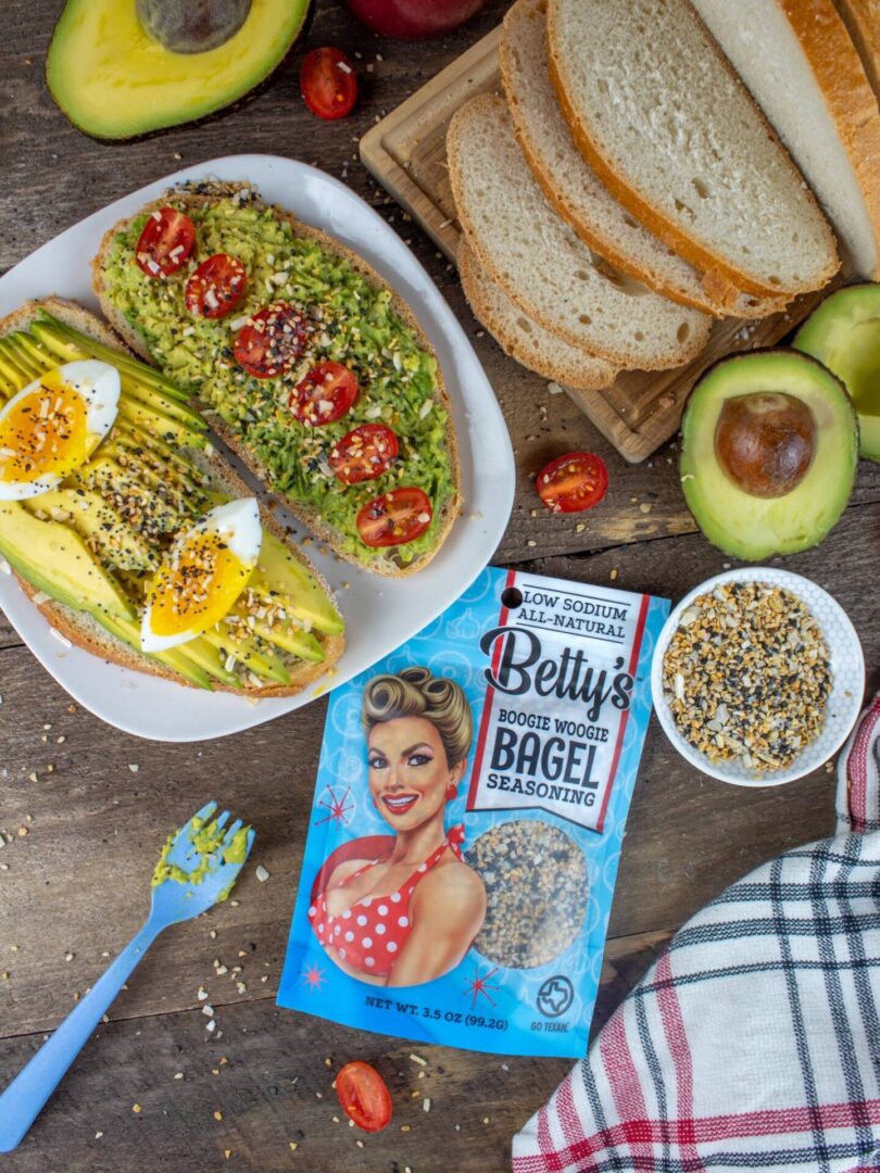 A table with food and a bag of betty 's bagel.